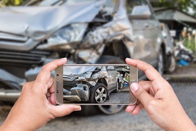 Taking a photo of an accident scene.