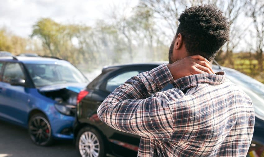 A man holding his neck after a rear end collision