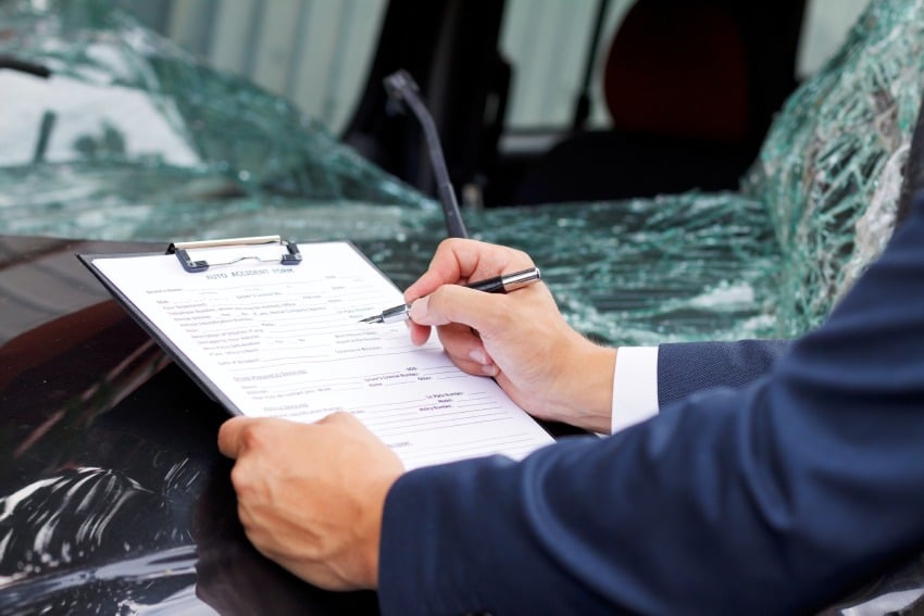 Closeup of someone filling up an accident report