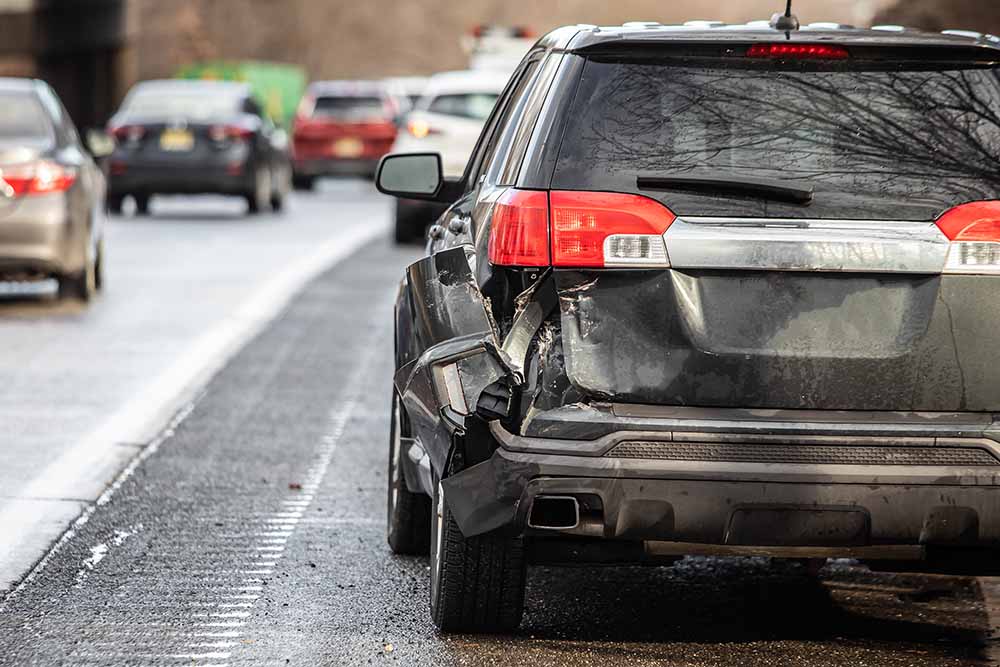 Closeup of black motor vehicle rear damage after crash in NY