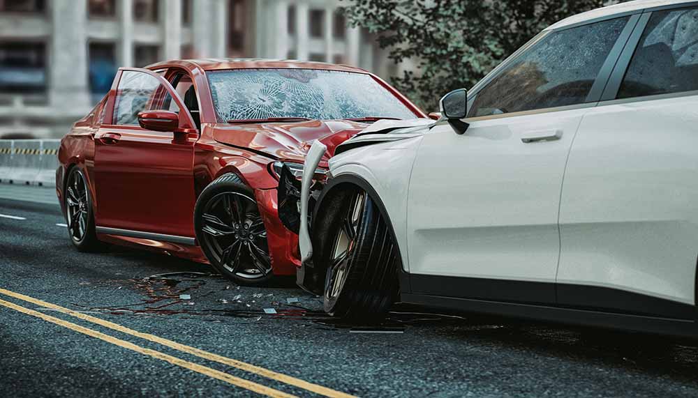 A red and white car, crumpled from impacting one another from the front after a collision.