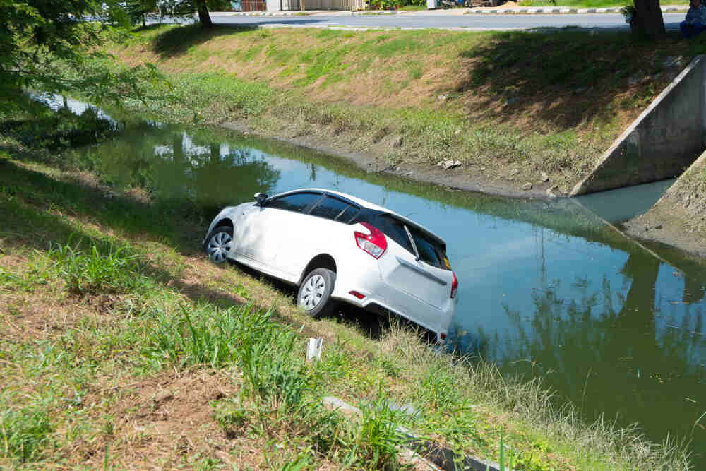 A white car pulled from a Florida canal after a car accident. 